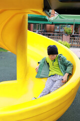 Child rolling down spiral slide