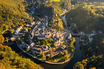 Aerial view of Esch-sur-Sure medieval town in Luxembourg famous for its ancient Castle. Forests of Upper-Sure Nature Park, meander of winding river Sauer, near Upper Sauer Lake. Canton Wiltz. - obrazy, fototapety, plakaty