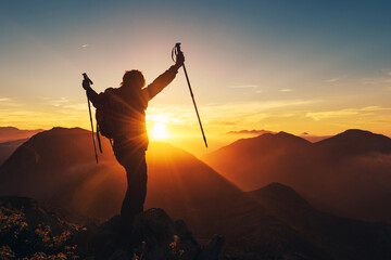 mountaineer man making summit on the mountain at sunset. mountain sport and healthy lifestyle