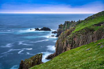 Rock cliffs at sunset seen from Land‘s End view point in Cornwall. United Kingdom