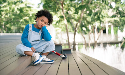 Boring kid with afro hair in the park
