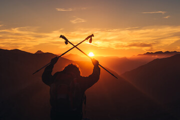 hiker celebrating reaching the top of the mountain at sunset. mountain sport and healthy lifestyle