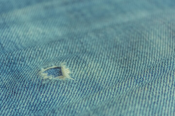 fabric ripped hole classic denim jeans close up texture