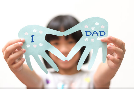 Handmade recycled craft blue card paper in hand shape with heart inside with text I love dad from Asian kid child daughter for daddy in Father's day holiday isolated on white background