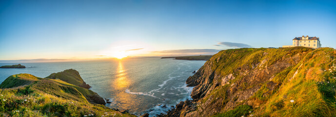 Love rock cliffs panorama of Mullion Cove at sunset in Cornwall. United Kingdom