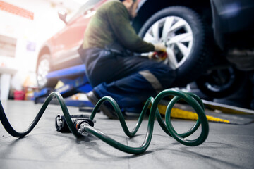 Concept Replacement of winter and summer tires. Mechanic unscrew wheels from car