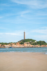 Scenic view of the lighthouse on the beautiful shore with large stones. The beauty of nature. Amazing places in the world. bay with crystal water