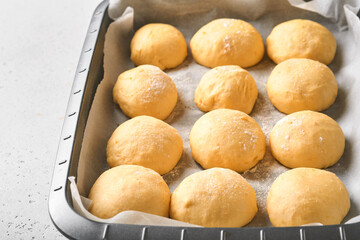 Raw yeast dough balls background in frying pan before baking. Concept home baking bread, buns or cinnabon or making dough.