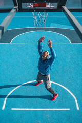Attractive athlete standing and stretching himself