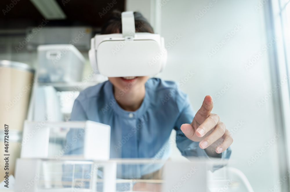Fototapete architects female wearing virtual reality headsets for work with virtual reality modeling software a
