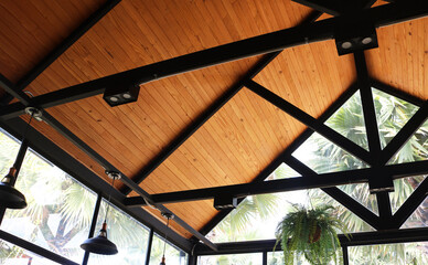 Wooden ceiling installed under hip roof for glass house nordic style.