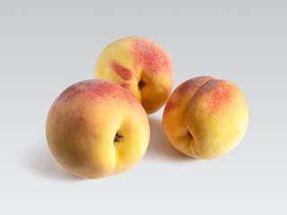 Ripe, juicy peaches on a light background