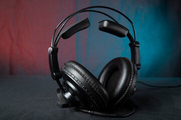 Plakat Headphones for a computer on a dark background. Audio device.
