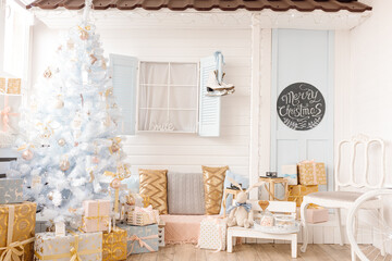 White Christmas tree decorated with silver golden pink Christmas balls and beautiful glass balls on sparkling and fairy white blue branch, decorative lights. Photo studio decor, house, window