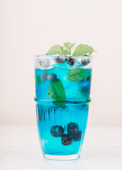 Tequila based blue cocktail with blueberry. Selective focus. Shallow depth of field.