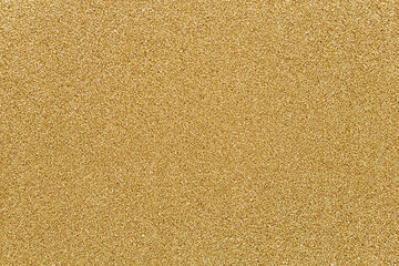 Smooth, homogeneous surface of decorative quartz sand of golden color