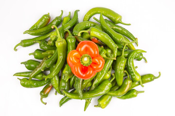 green hot peppers and red bell peppers on a white background. vitamin vegetables for health