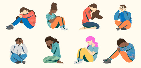 Young people, teenagers suffering from psychological diseases, depression, anxiety. Girls and young people are sitting sadly on the floor, covering their faces with their hands