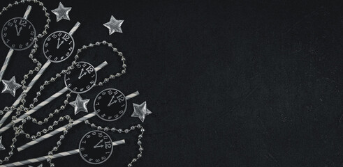 Paper watches, stars and beads on black.