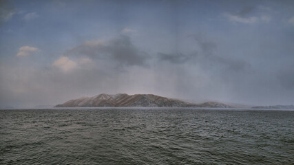 Mountain behind the river in a foggy areola