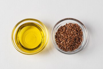 Flaxseed oil flaxseeds in glass containers on a white background with copy space