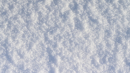 Winter snow background, ice crystals sparkling on snow, christmas texture, sparkling snowflakes in snowdrift.