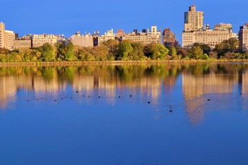 Fototapeta na wymiar Buildings and Trees Reflecting on a Lake