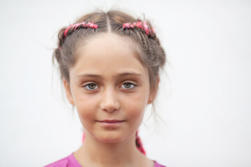 Emotional portrait of a 9-year-old girl with red pigtails