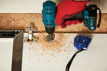 Installation of furniture hinges in the kitchen cabinet door. Tools and furniture fittings needed...