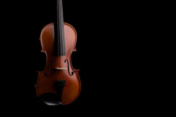 Fototapeta premium A violin or viola with four strings with a beautiful soft light hitting it on a black background. No.4