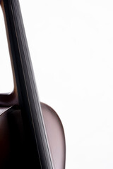 A violin or viola with four strings with a beautiful soft light hitting it on a white background. No.16