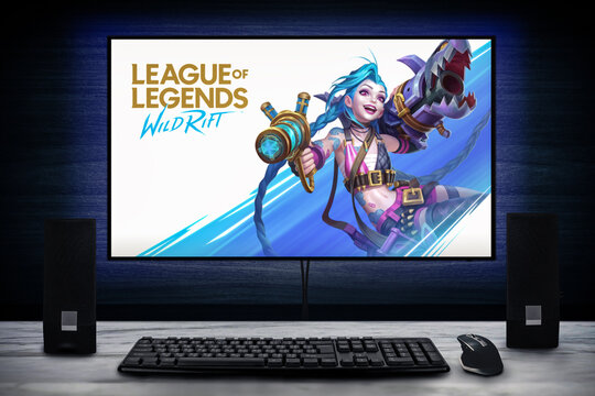 Cali, Colombia - November 7, 2021: League of Legends: Wild Rift video game logo on PC screen with keyboard, mouse and speakers