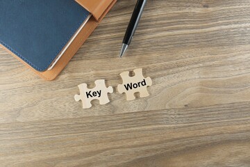 KEYWORD text on the missing puzzles on the wooden table 