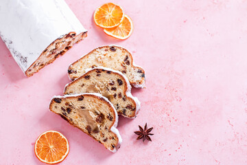 Christmas Stollen border web banner with dried orange slices on pink, top view