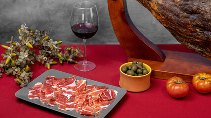 Plate of Iberian Acorn-fed Serrano Ham with a glass of red wine