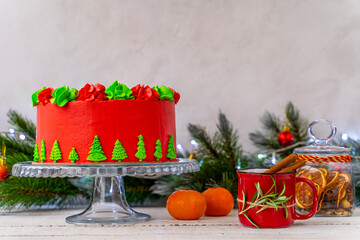 Christmas cake decorated with Christmas trees. Decoration for the holiday. Beautifully served table for the celebration. Copy space.