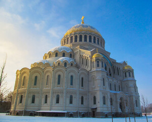 The Naval Cathedral of Saint Nicholas (Marine Cathedral) in Kronstadt, St. Petersburg, Russia on a winter day. Beautiful building with the illuminated sun against the blue sky.