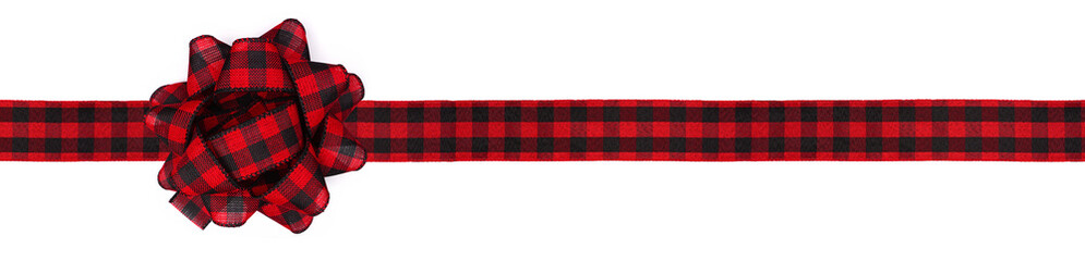Christmas gift bow and ribbon with red and black buffalo plaid pattern. Long border isolated on a...