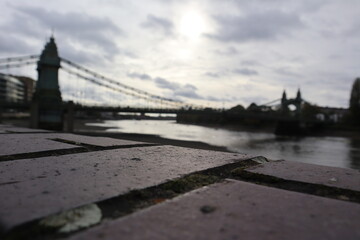 Fototapeta na wymiar Thames brick riverbank at Hammersmith Bridge West London