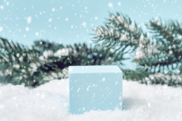 Winter Christmas background with podium for product presentation. Cubic pedestal in a snowdrift,...