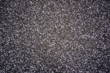 Snow crumbs on paving slabs, background