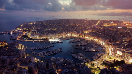 Obraz premium Aerial drone photo of iconic round port and Marina of Zea or Passalimani at dusk with beautiful colours, Piraeus, Attica, Greece