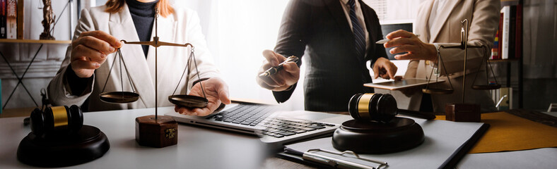 Business and lawyers discussing contract papers with brass scale on desk in office. Law, legal...