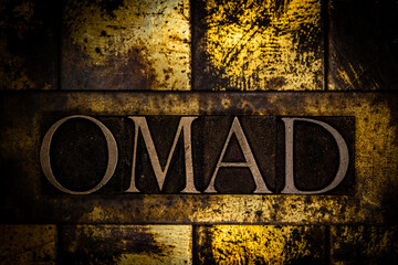 OMAD text on textured grunge copper and vintage gold background