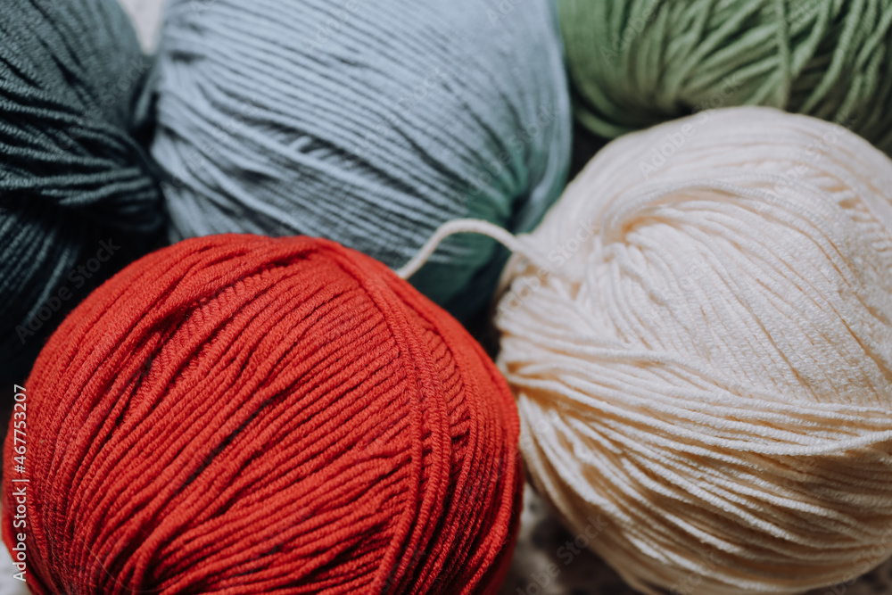 Poster colored skeins of wool lie in rows