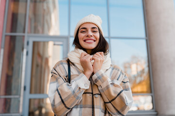young smiling woman walking in street in winter