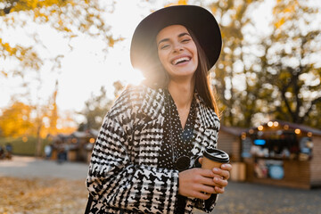 attractive young woman walking in autumn wearing coat
