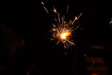 A burning sparkler on the black