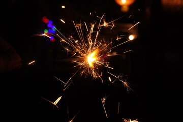 A burning sparkler on the black
