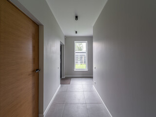 Modern interior of luxury private house. Hallway with tile floor.